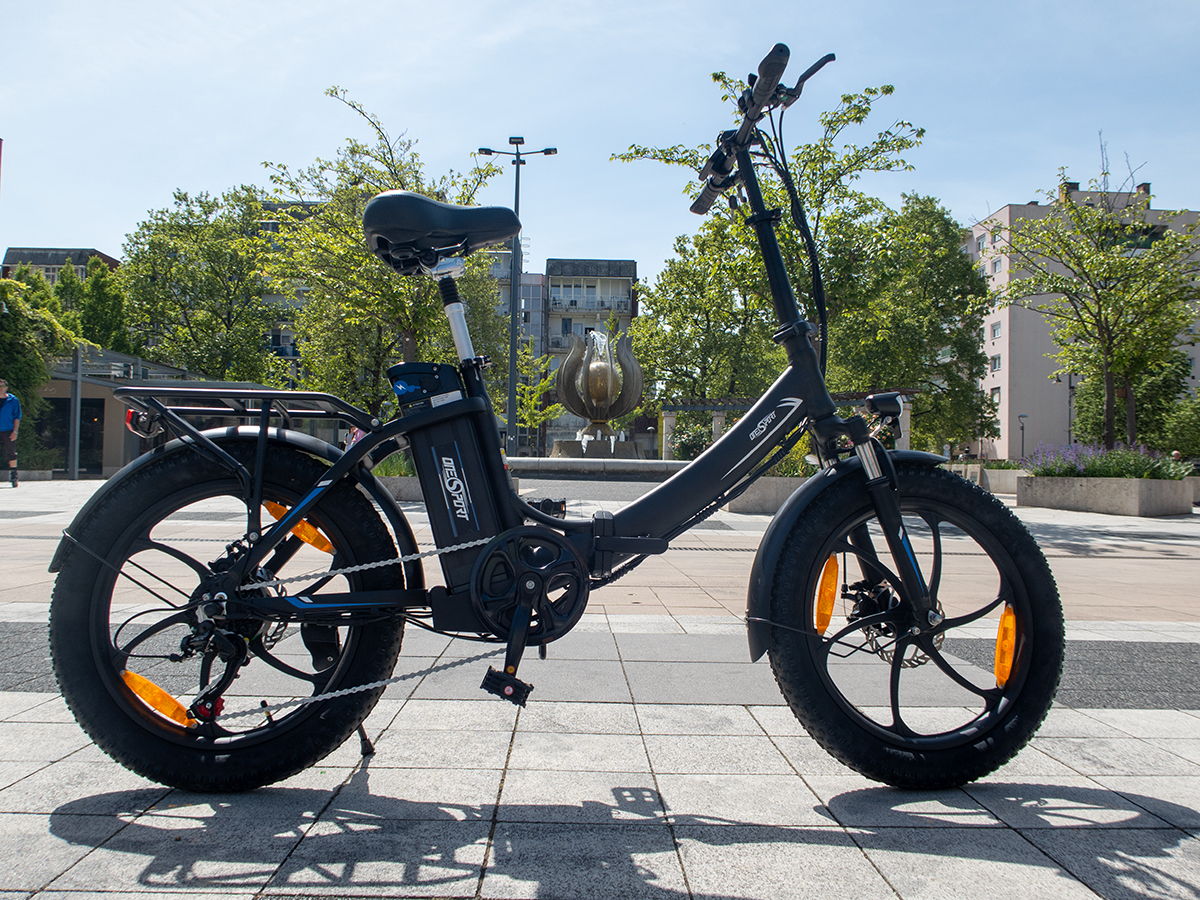 a black bike on a sidewalk OneSport OT16